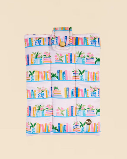 Foldable shopping bag with book and plant pattern on a beige background