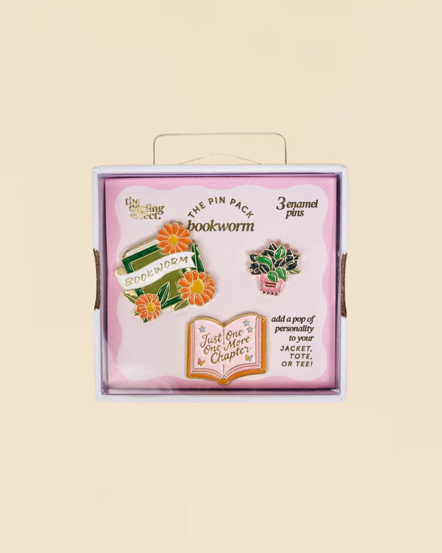 Box of 'bookworm' pins with decorative elements on a beige background