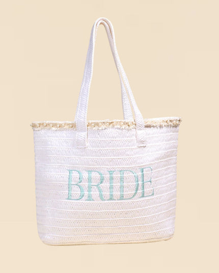 White tote bag with 'BRIDE' text on a beige background