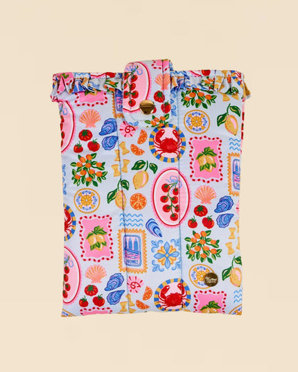 Colorful patterned bag with fruits and vegetables on a beige background