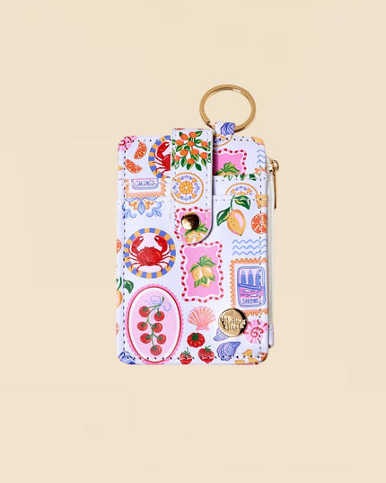 Colorful keychain pouch with various designs on a beige background