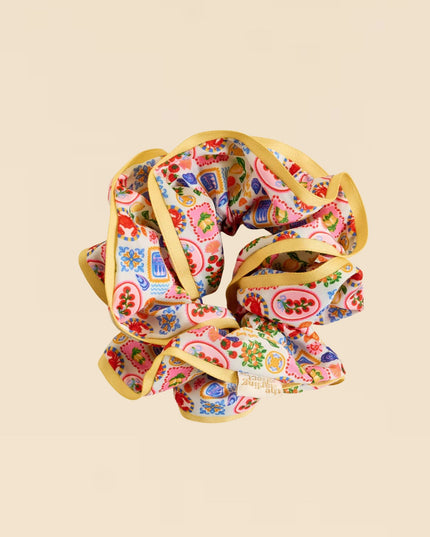 Colorful scrunchie with paisley pattern on a beige background