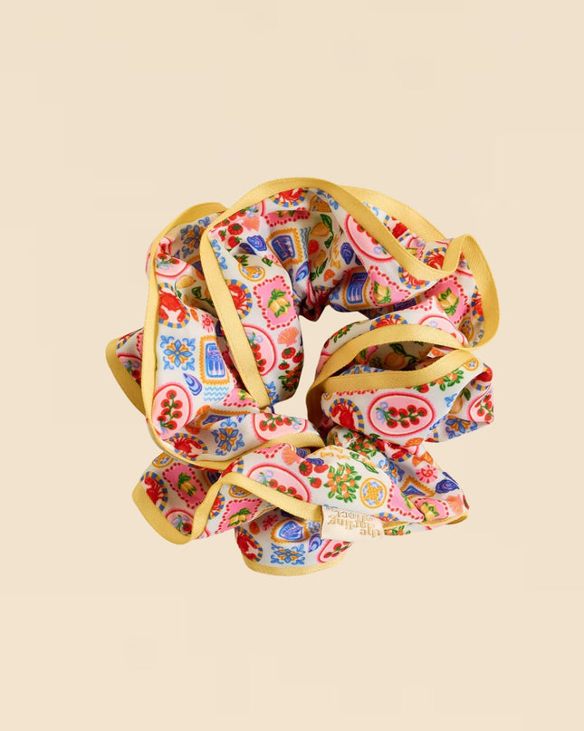 Colorful scrunchie with paisley pattern on a beige background
