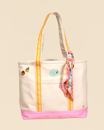 Beige tote bag with colorful accents and a scarf on a beige background