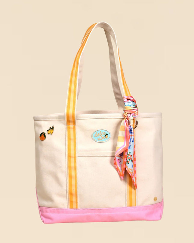 Beige tote bag with colorful accents and a scarf on a beige background