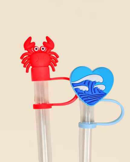 Red crab-shaped straw with a blue heart-shaped straw on a beige background