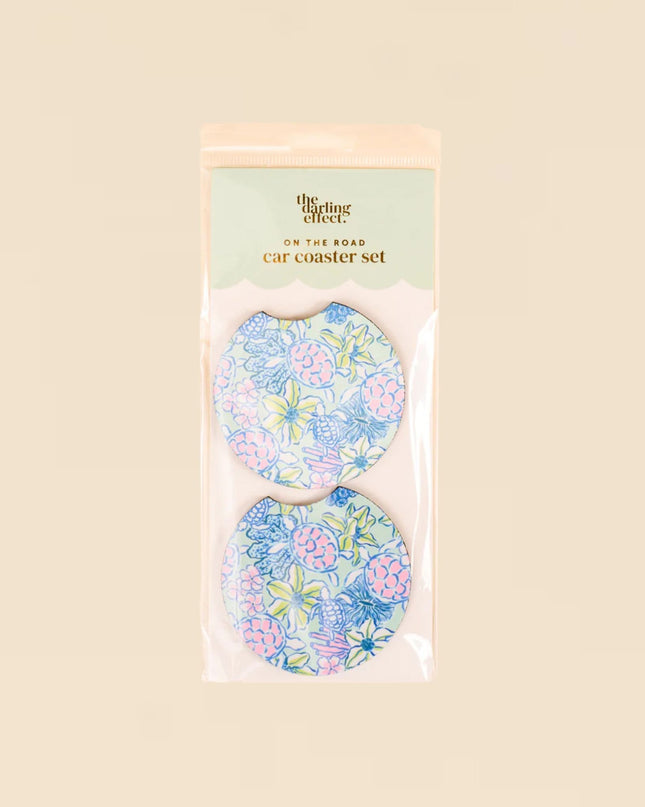 Set of floral car coasters in packaging on a beige background