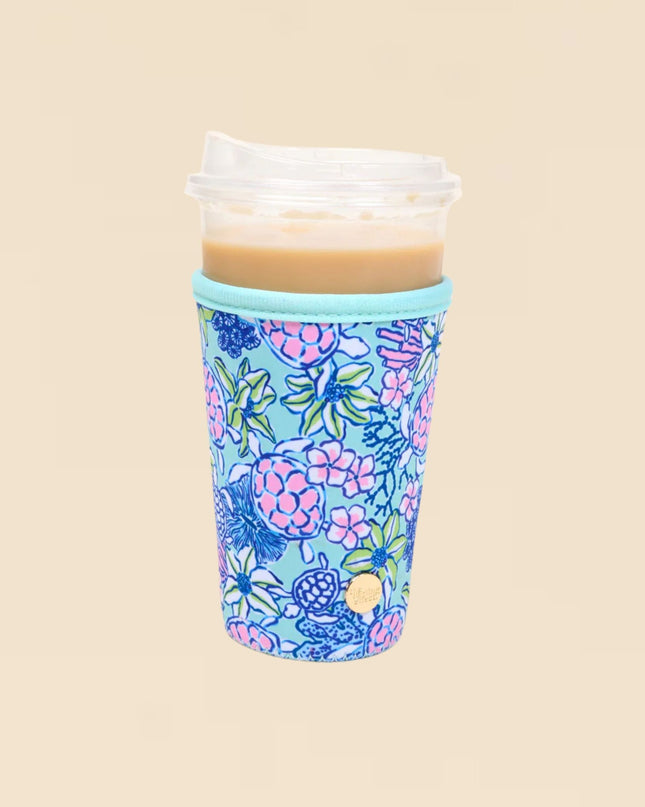 Floral-patterned cup sleeve with a cup of coffee on a beige background