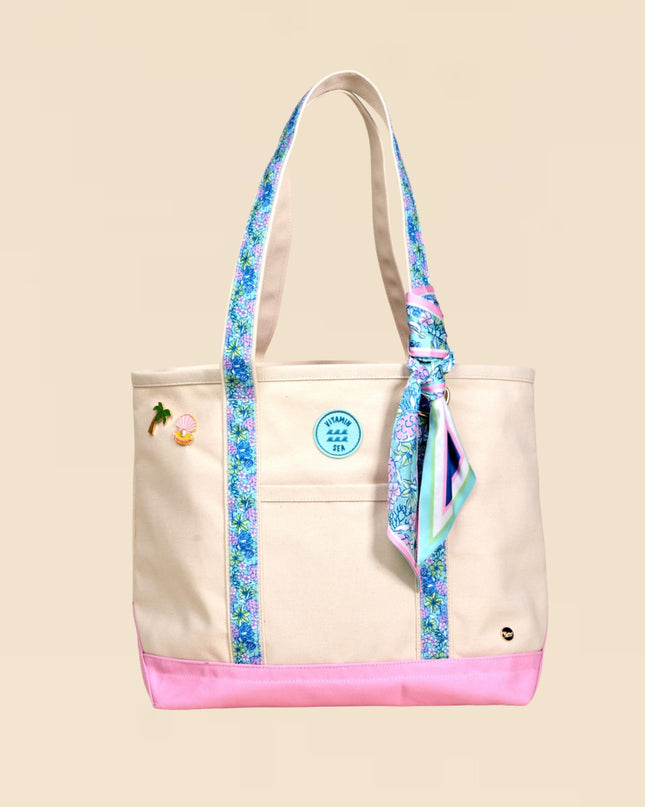 Beige tote bag with floral straps on a beige background