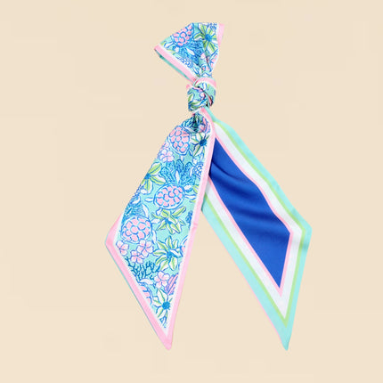 Floral patterned hair tie on a beige background