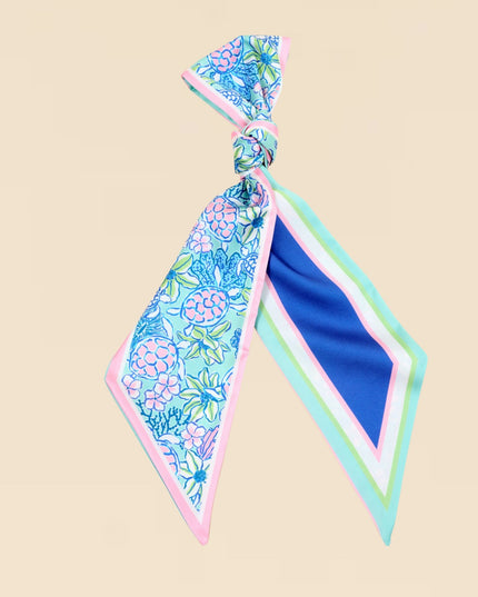 Floral patterned hair tie on a beige background