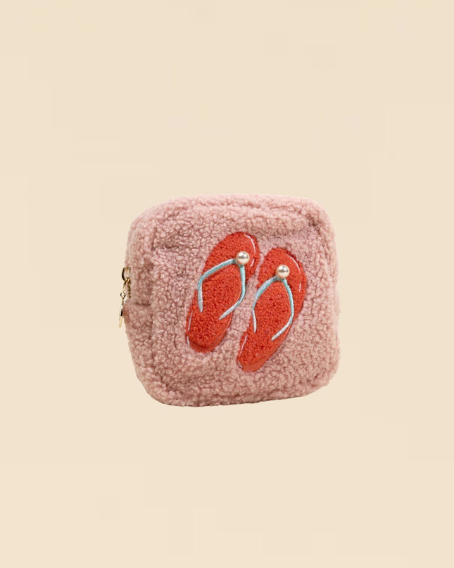 Pink textured pouch with red flip-flop design on a beige background