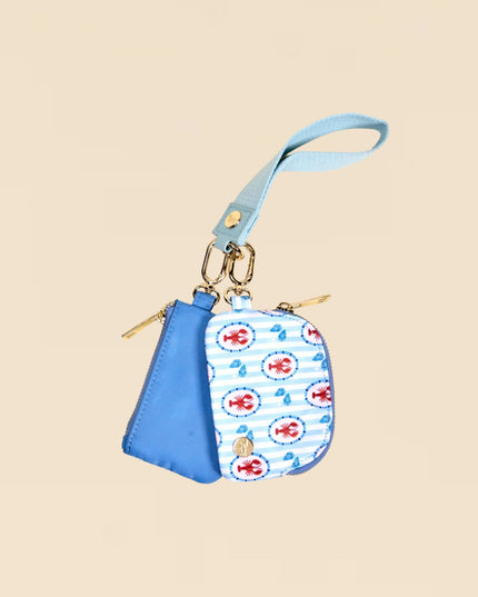 Small blue pouch with a patterned flap on a beige background