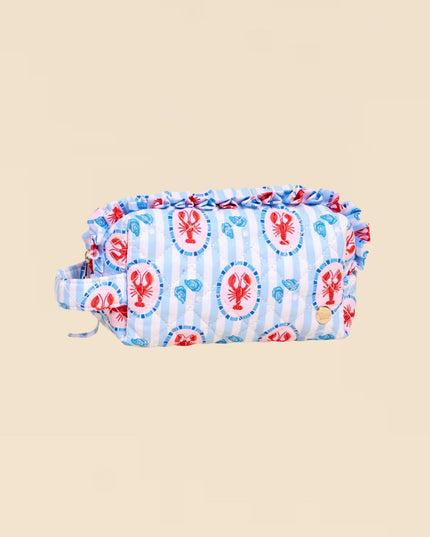 Fabric roll with lobster pattern on a beige background
