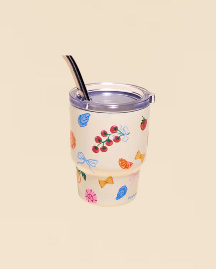 Clear tumbler with colorful designs on a beige background