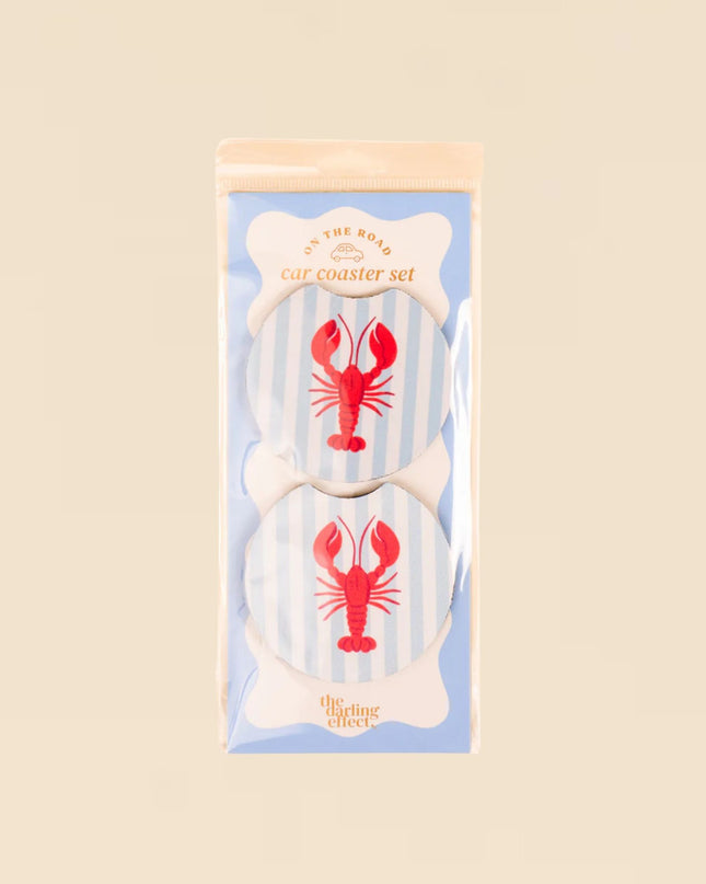 Set of coasters with lobster design in packaging on a beige background