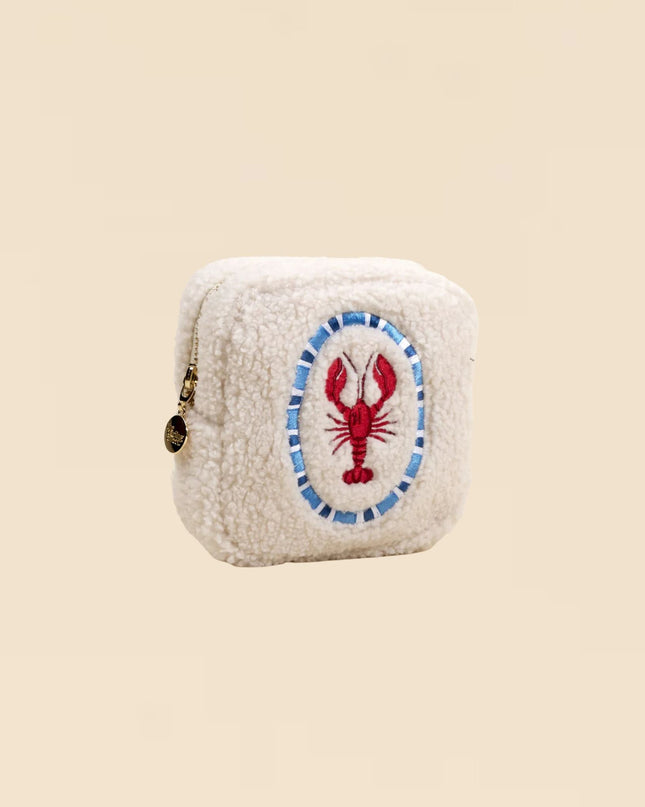 Small cream-colored pouch with a lobster design on a beige background