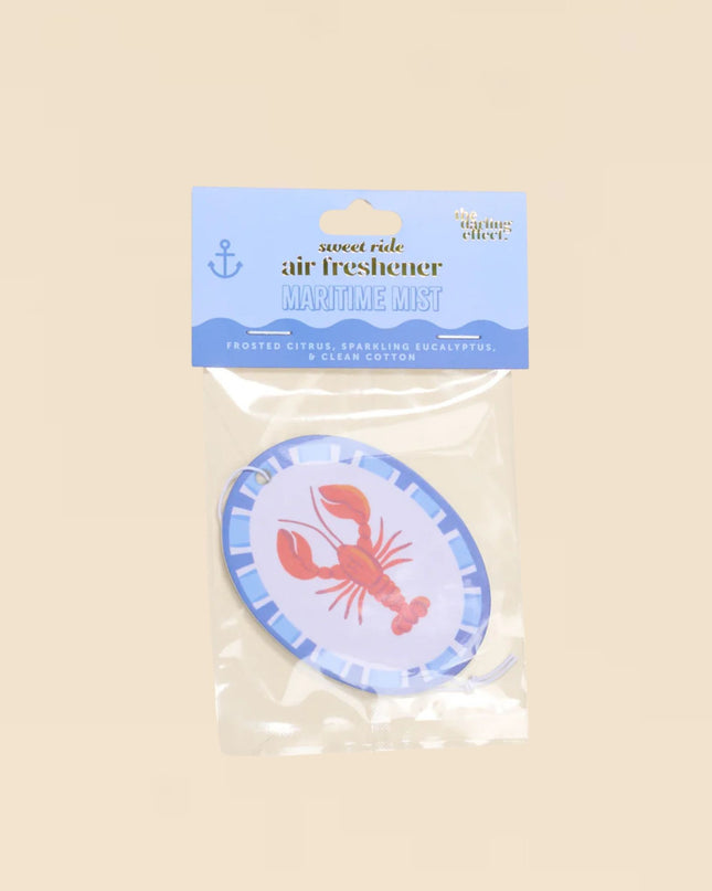 Air freshener with lobster design in clear packaging on a beige background