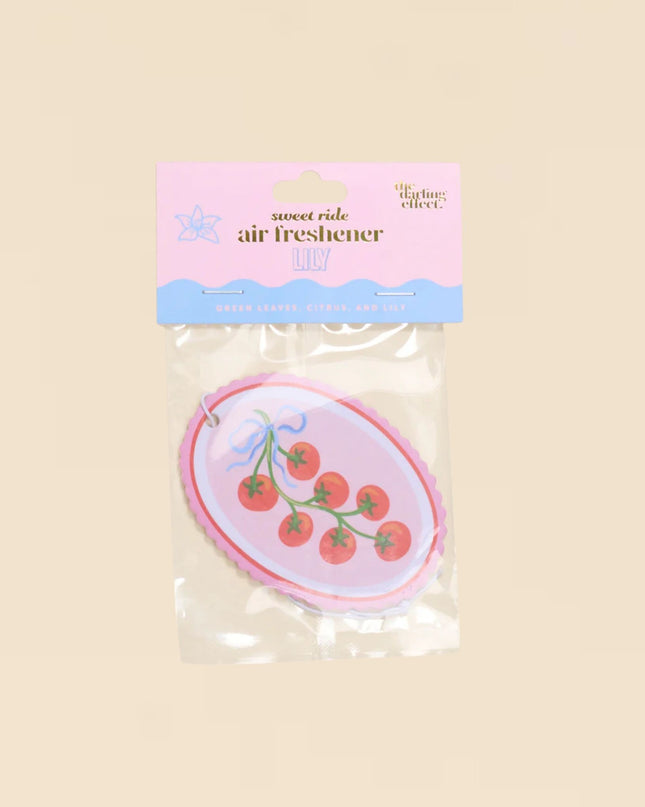 Air freshener with cherry design on a beige background