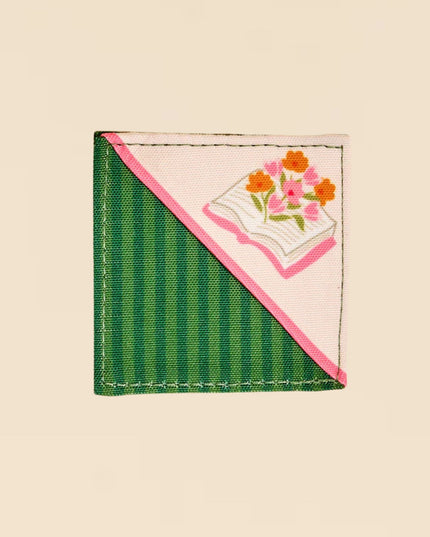 Small fabric patch with floral design on a beige background