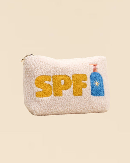 Pouch with 'SPF' text and sun icon on a beige background