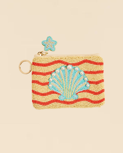 Beaded pouch with shell design and star accessory on beige background