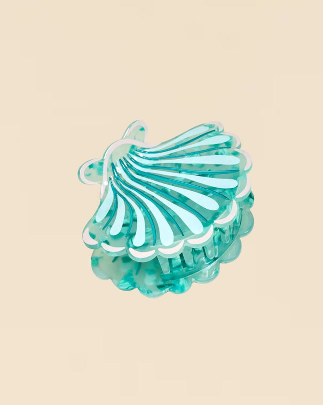 Turquoise hair clip on a beige background