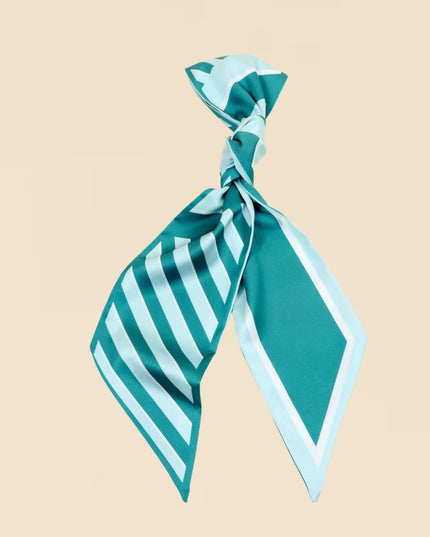 Teal and light blue striped scarf tied into a knot on a beige background