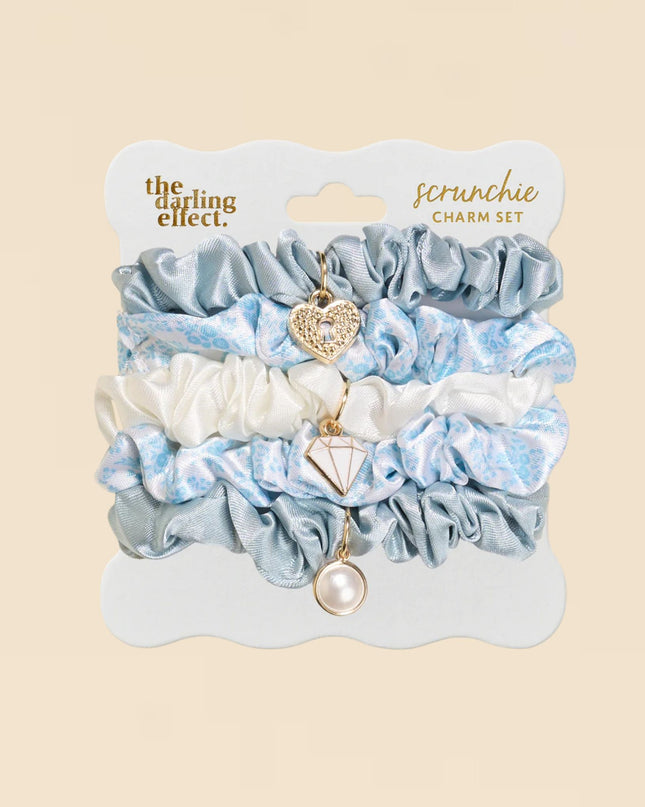 Set of scrunchies with charms on a beige background