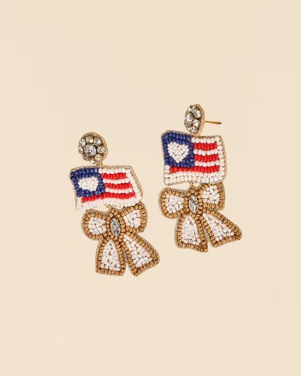 Earrings with American flag design on a beige background