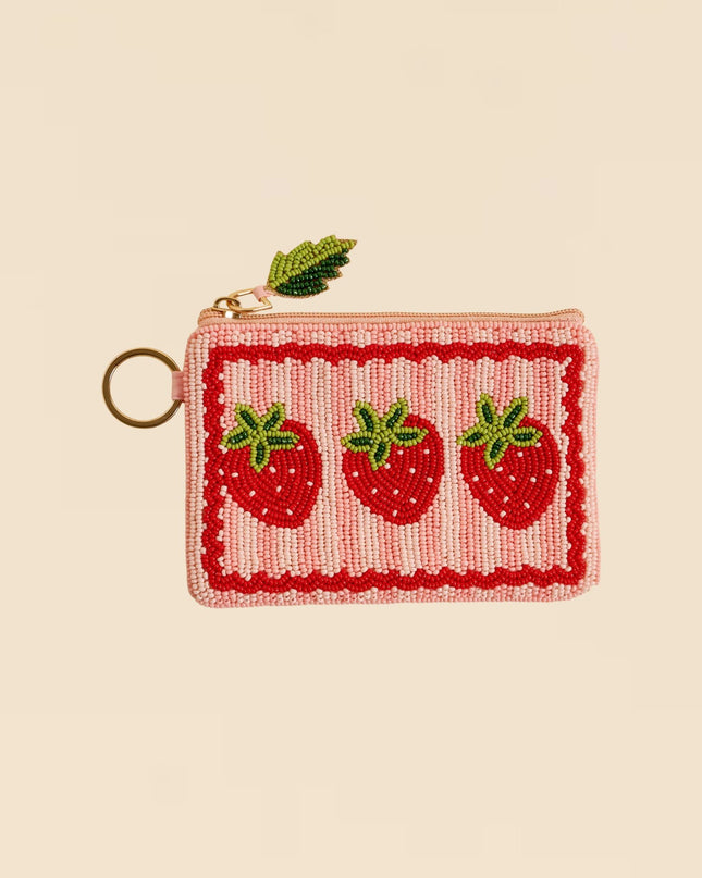 Small pouch with strawberry design on a beige background
