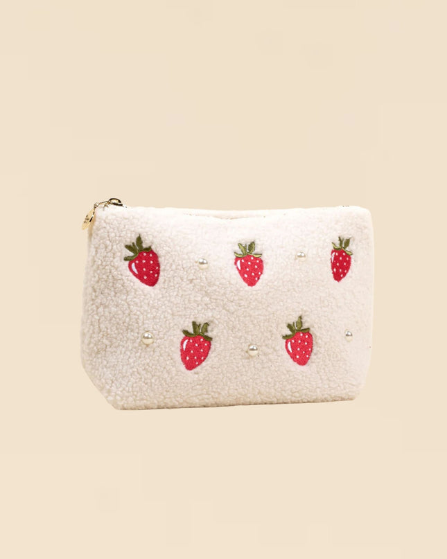 White pouch with strawberry patterns on a beige background