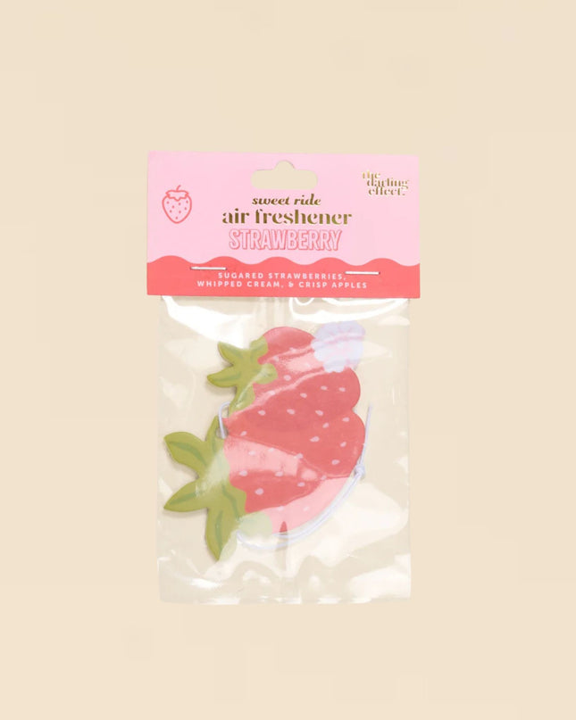 Strawberry air freshener packaging on a beige background
