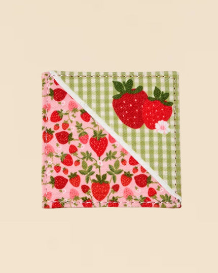 Fabric square with strawberry pattern on a beige background