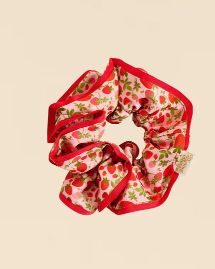 Scrunchie with strawberry pattern on a beige background