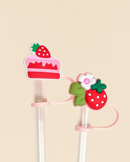 Strawberry-themed hair clips on a beige background