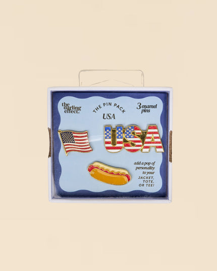 Box of USA-themed pins with American flag design on a beige background