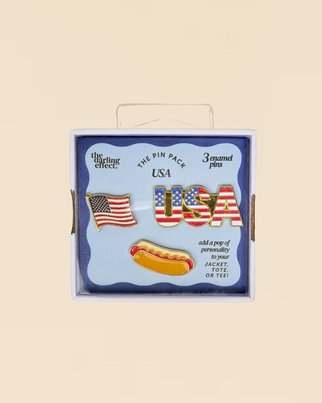 Box of USA-themed pins with American flag design on a beige background