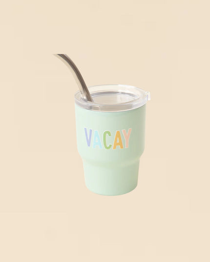 Mint green tumbler with 'VACAY' text on a beige background