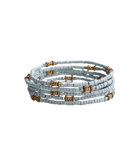 A stack of five beaded wrap bracelets in a light blue-gray color, accented with small metallic gold spacer beads, shown on a plain white background.