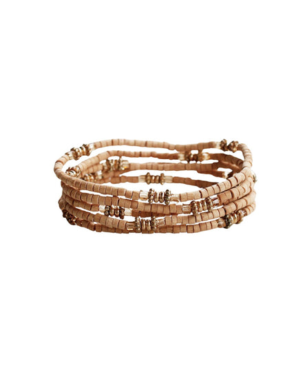 A stack of four beaded stretch bracelets made from light tan wood discs and small metallic spacer beads, shown on a plain white background.
