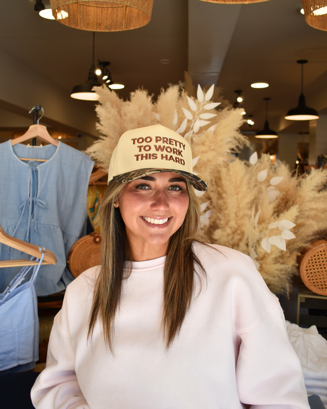 Woman wearing a cap with text in a store setting