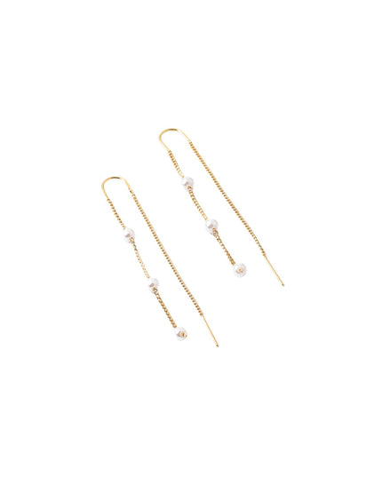 A pair of gold drop earrings with small white pearl-like beads, shown on a plain white background.