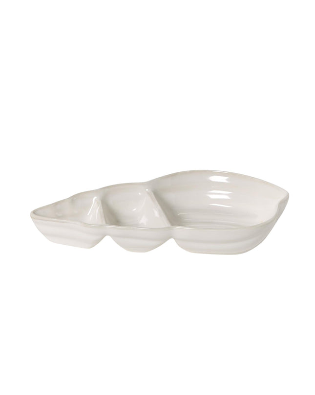 White ceramic dish with a wavy edge on a white background