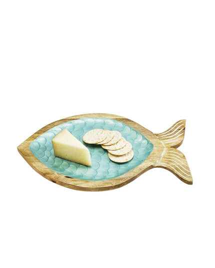 Fish-shaped plate with cheese and crackers on a white background