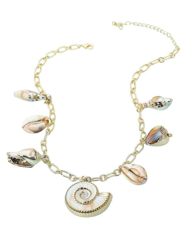 Gold necklace with shell charms on a white background