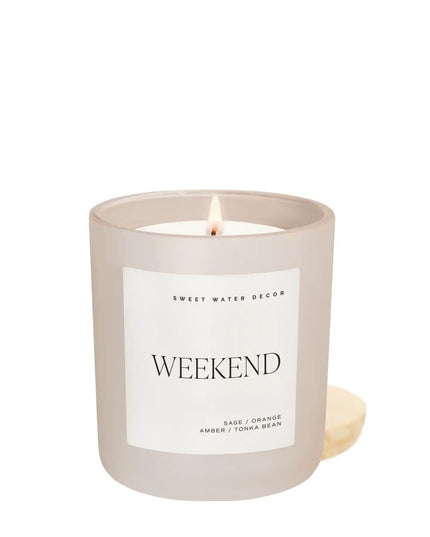 Frosted candle with a lit wick and 'Weekend' label on a white background