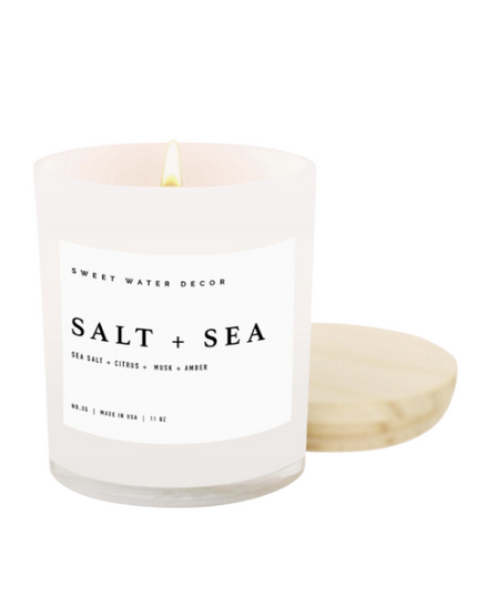 Candle with 'Salt + Sea' label on a white background